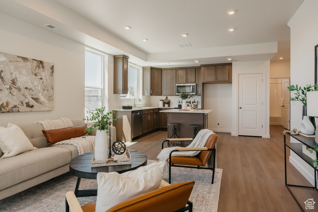 Living room with wood finished floors and recessed lighting