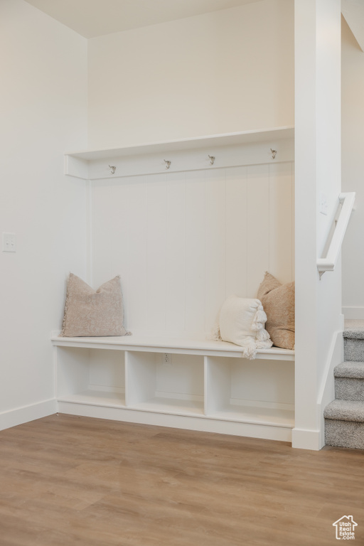 Mudroom with wood finished floors and baseboards