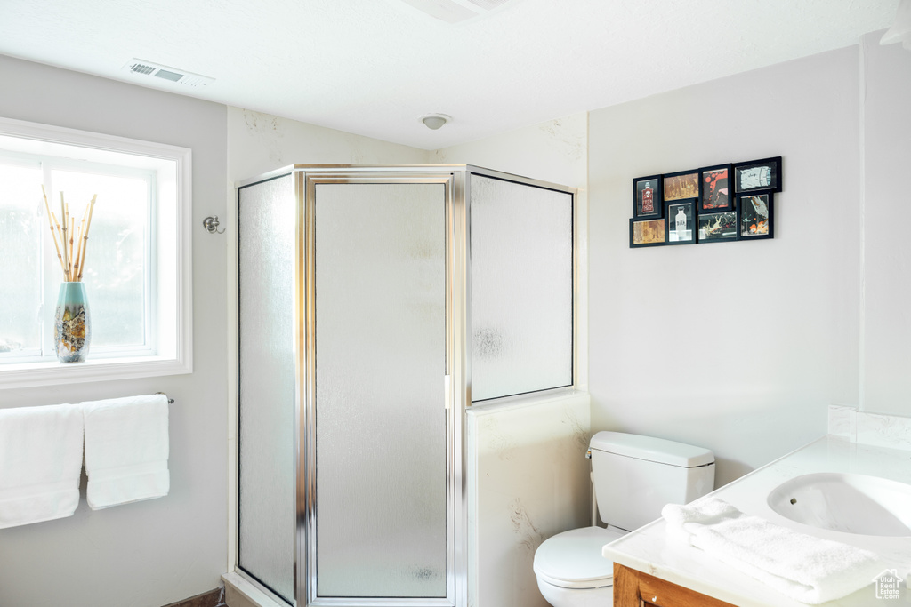 Full bath featuring vanity and a shower stall