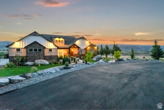 View of front of home with stone siding and board and batten siding