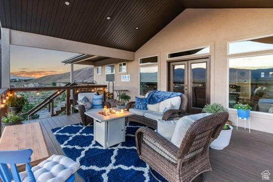 Wooden terrace with an outdoor living space with a fire pit