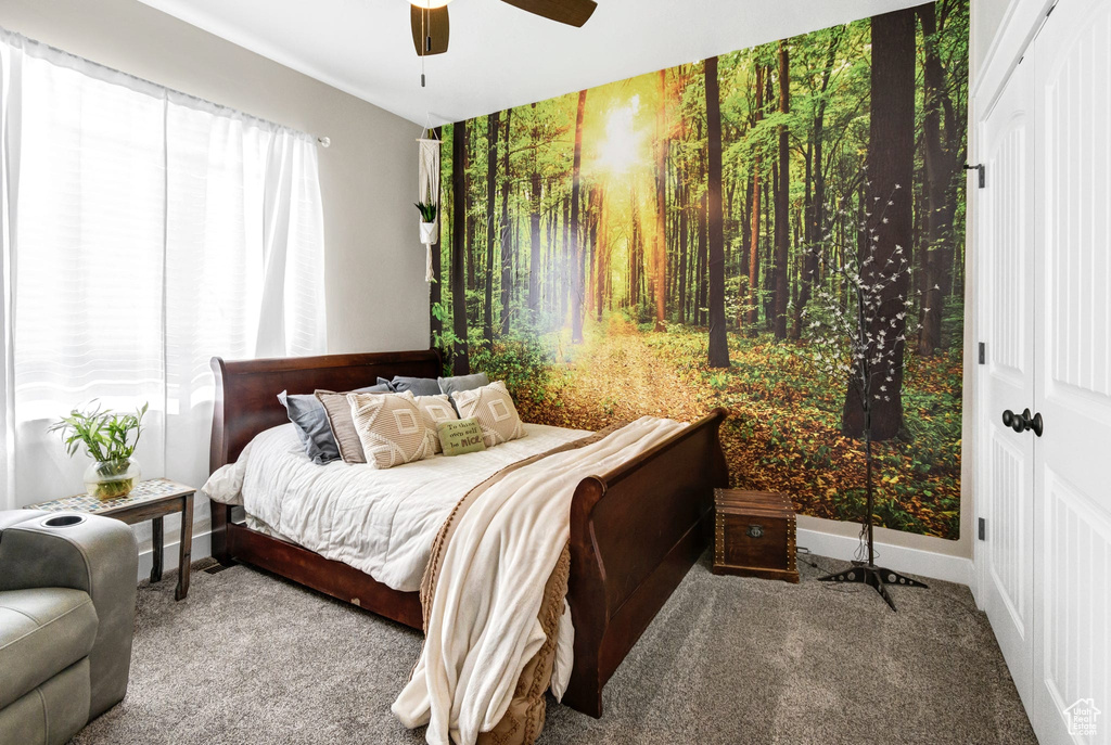 Carpeted bedroom with ceiling fan