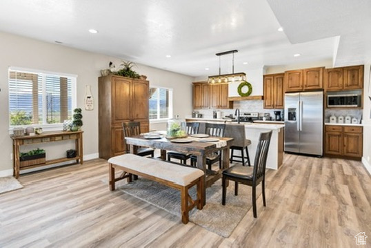 Dining area featuring light wood-style flooring and recessed lighting