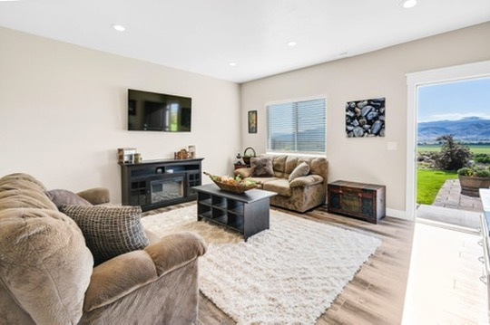 Living area with light wood finished floors, recessed lighting, and healthy amount of natural light