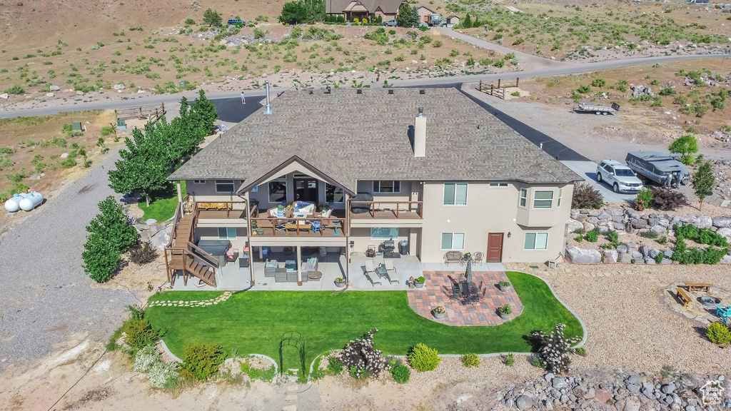 Back of property with a patio, stucco siding, stairs, and a balcony