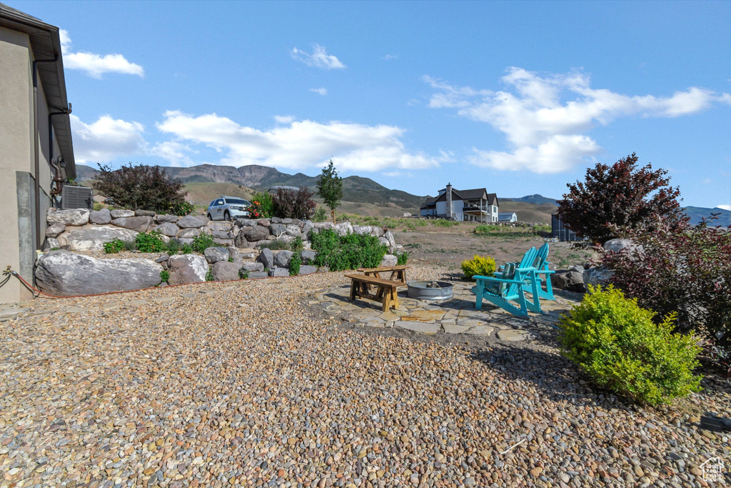 View of yard featuring a mountain view and a fire pit