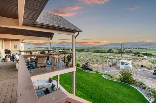 Deck with outdoor dining space and a lawn