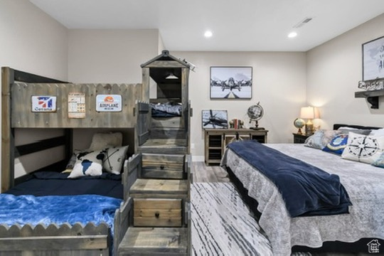 Bedroom with wood finished floors and recessed lighting