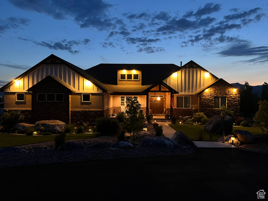 View of front facade with stone siding and board and batten siding