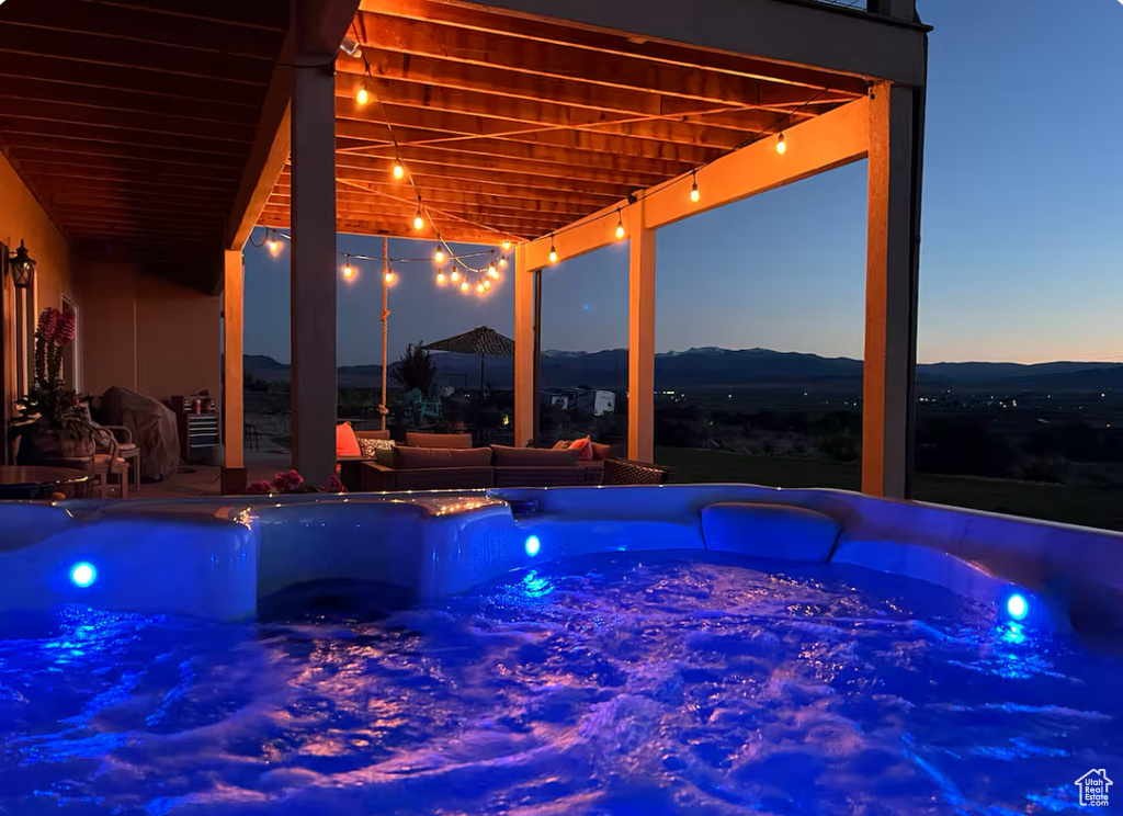 View of swimming pool featuring a hot tub and a mountain view