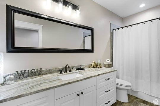 Bathroom featuring vanity and wood finished floors
