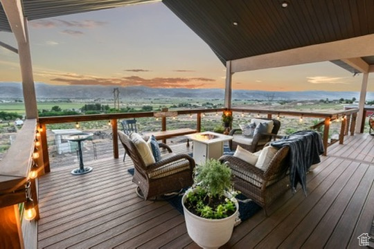 Deck with an outdoor living space with a fire pit