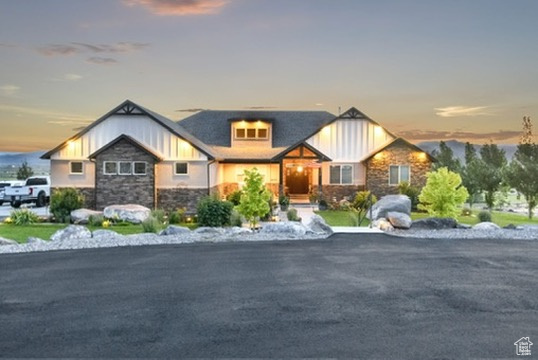 Craftsman-style home with stone siding and board and batten siding