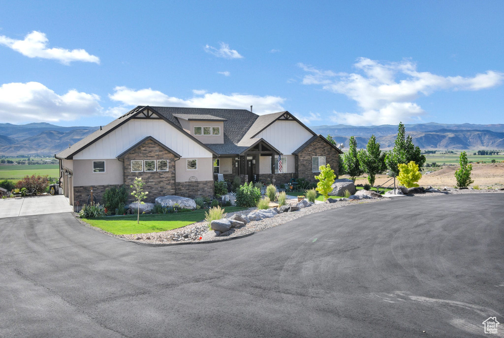 Craftsman-style house with stone siding and a mountain view
