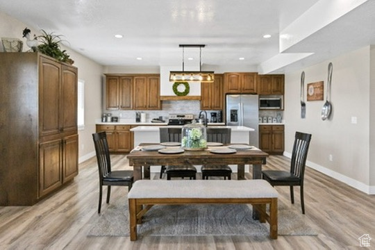 Dining room featuring light wood-style flooring and recessed lighting