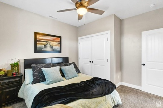 Bedroom featuring carpet flooring, a closet, and a ceiling fan