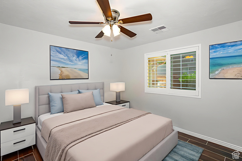 Bedroom with dark wood finished floors and ceiling fan