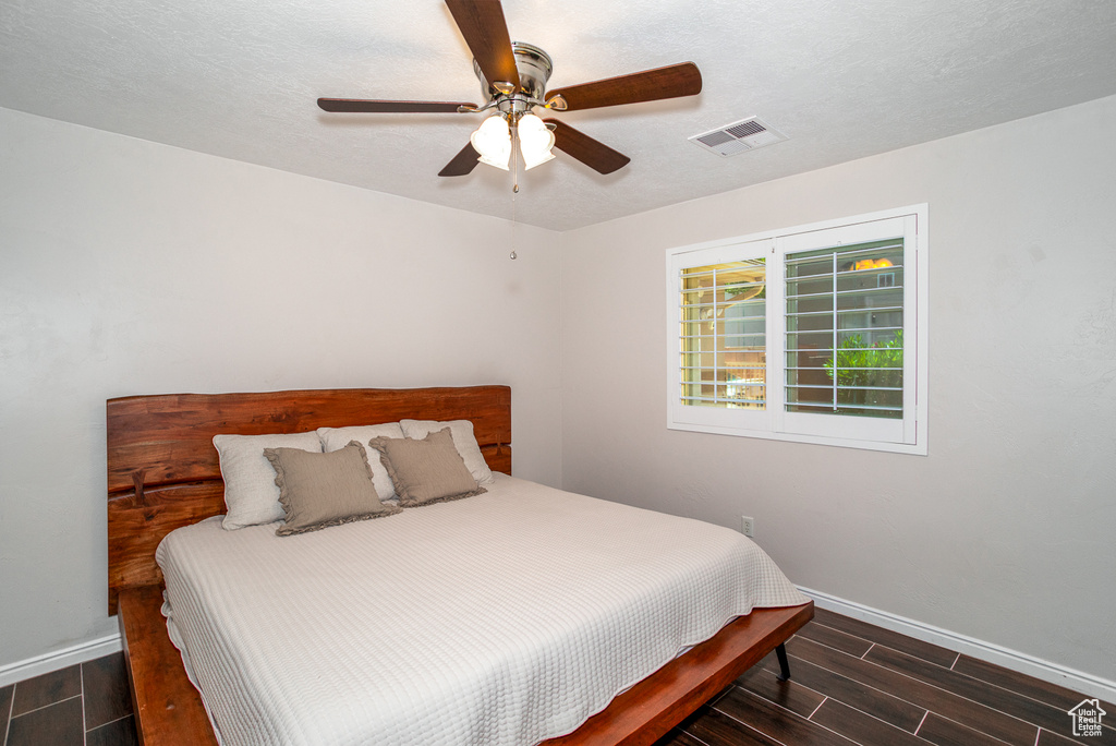 Bedroom with wood finish floors and ceiling fan