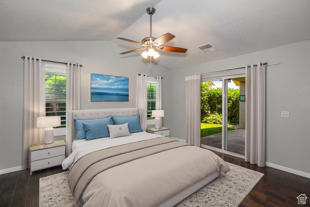 Bedroom with access to exterior, lofted ceiling, wood finished floors, and ceiling fan