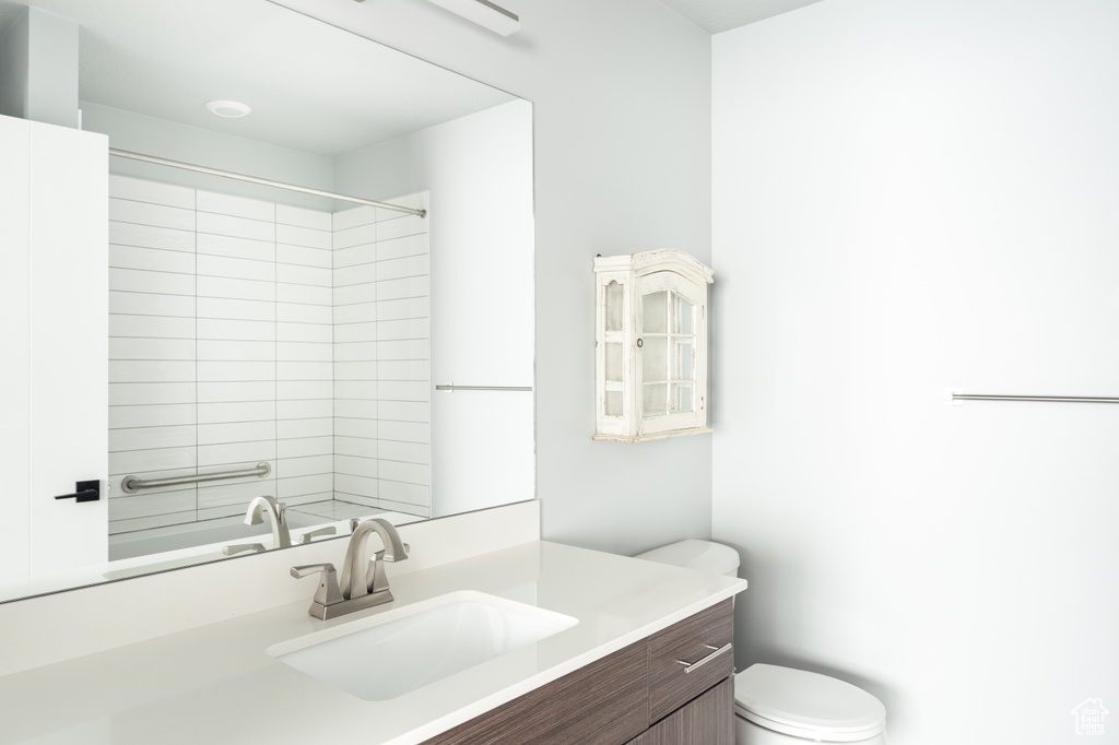 Bathroom with vanity, toilet, and a shower