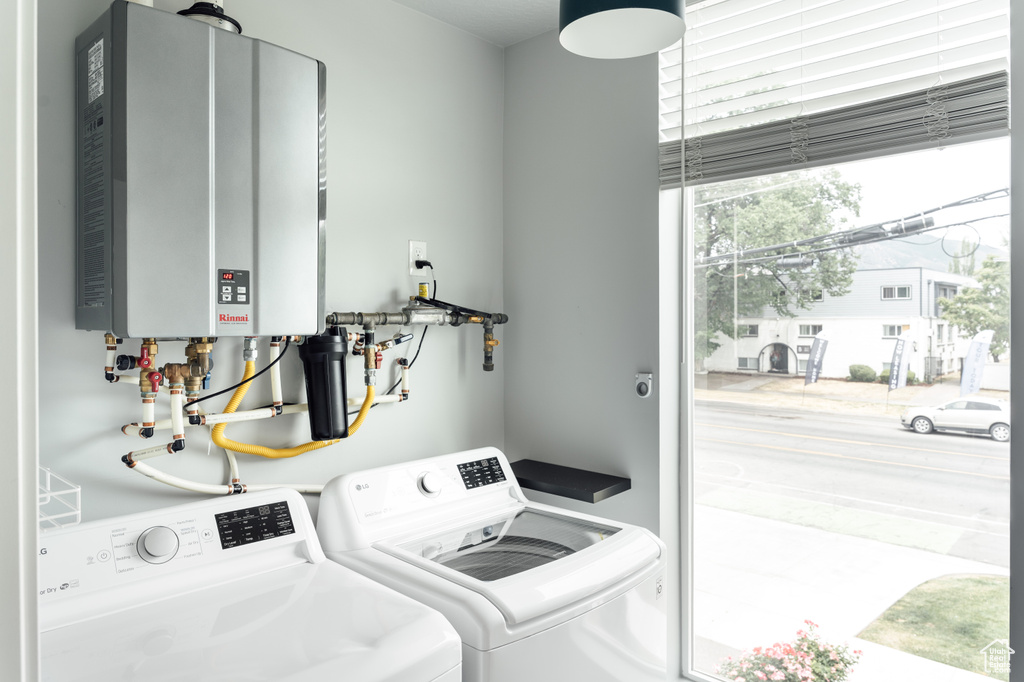 Laundry area featuring water heater and washer and dryer