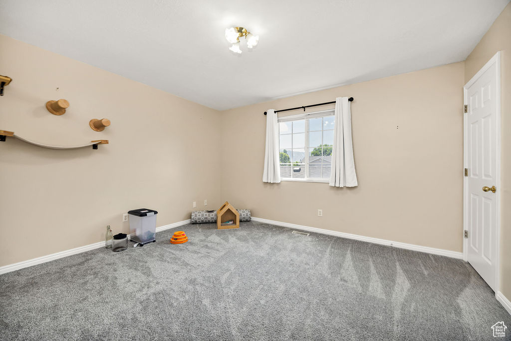 Empty room with carpet floors and baseboards