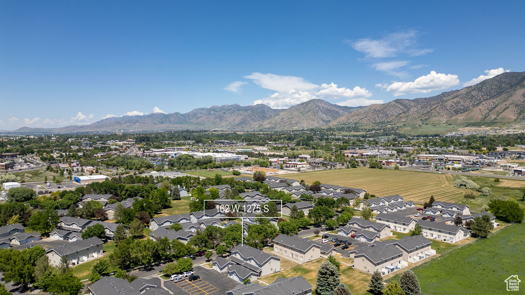 Aerial view of residential area featuring a mountainous background