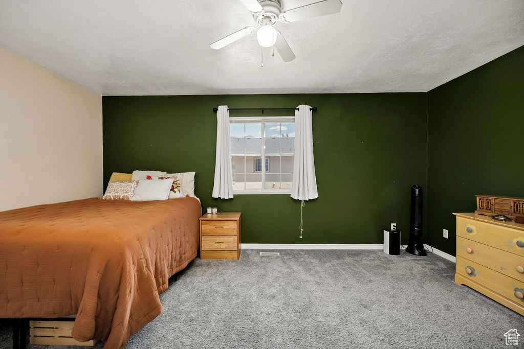 Bedroom featuring carpet and ceiling fan