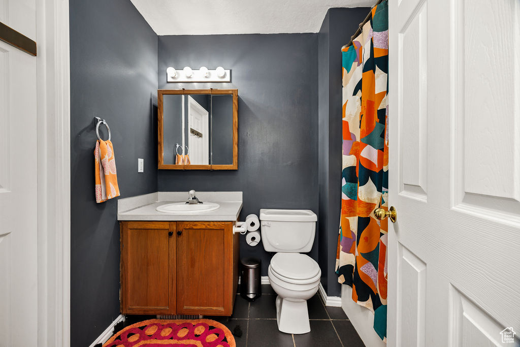 Full bath featuring vanity, tile patterned flooring, and a shower with shower curtain
