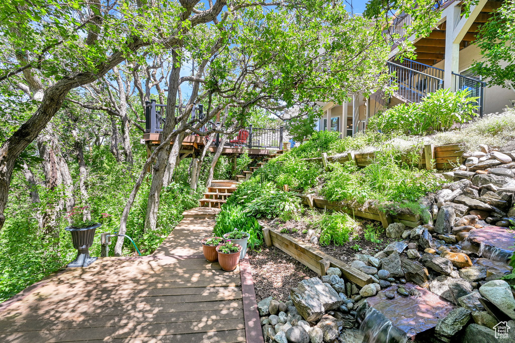 View of yard featuring stairs and a wooden deck
