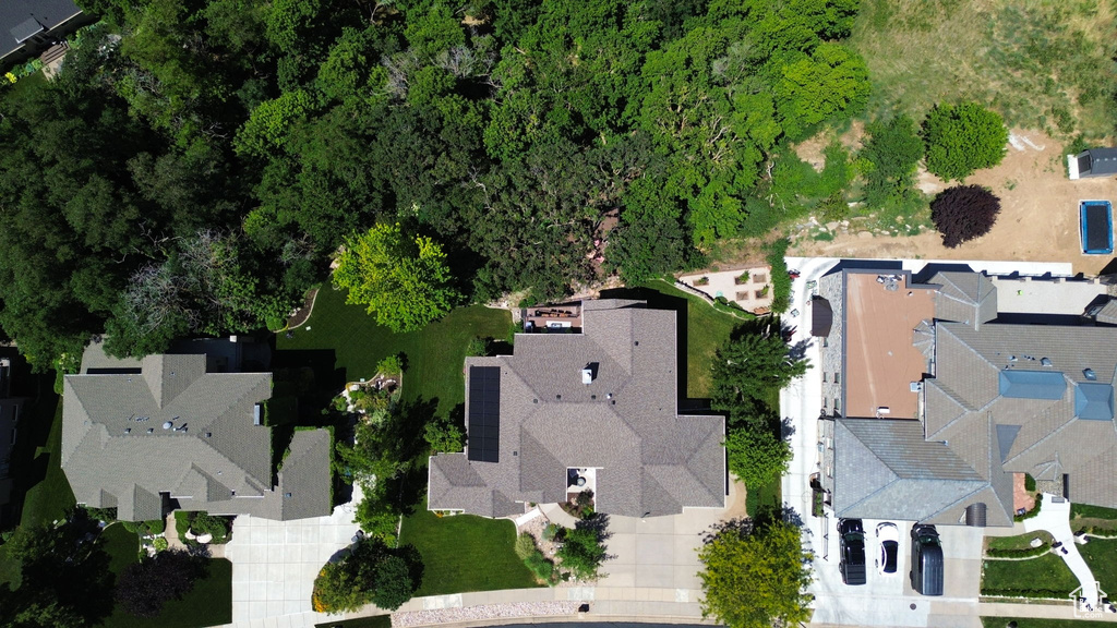 Aerial view of property and surrounding area with nearby suburban area