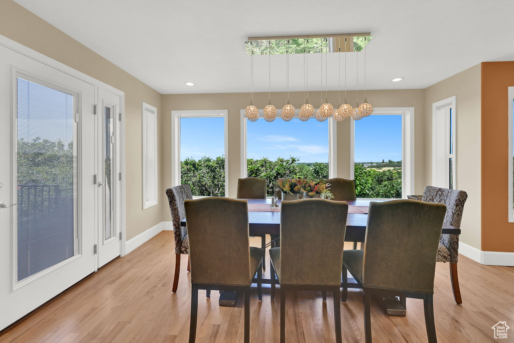 Dining area with healthy amount of natural light, light wood finished floors, and recessed lighting