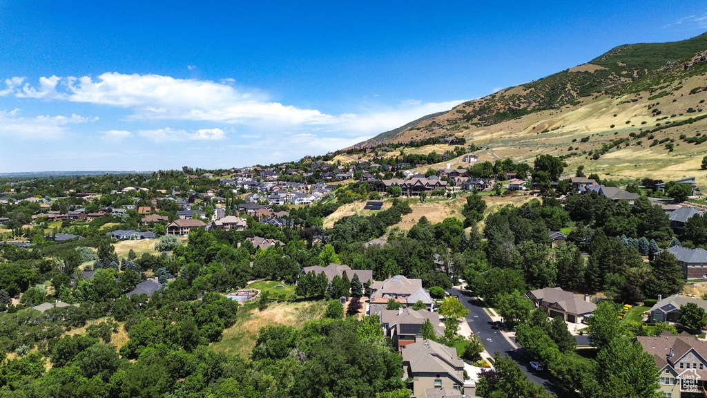 View of property location featuring nearby suburban area and a mountain backdrop