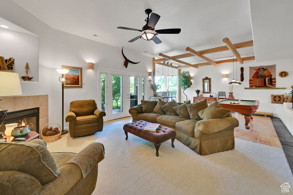 Living area featuring billiards table, a ceiling fan, and a tile fireplace