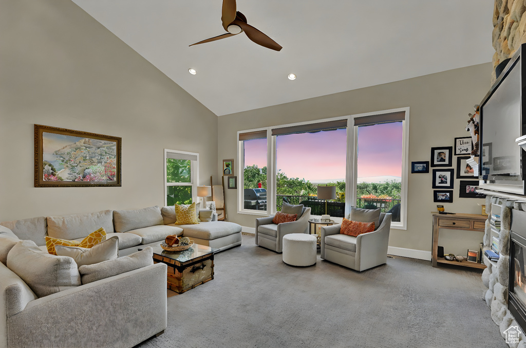 Living room featuring high vaulted ceiling, ceiling fan, carpet floors, and recessed lighting