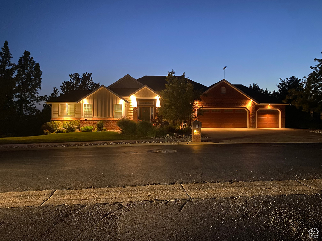 Ranch-style home featuring a garage, board and batten siding, and driveway