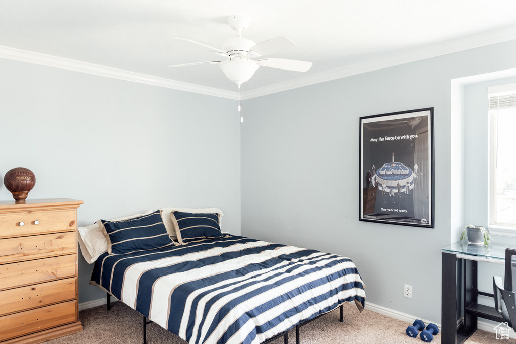 Bedroom featuring carpet flooring, crown molding, baseboards, multiple windows, and a ceiling fan
