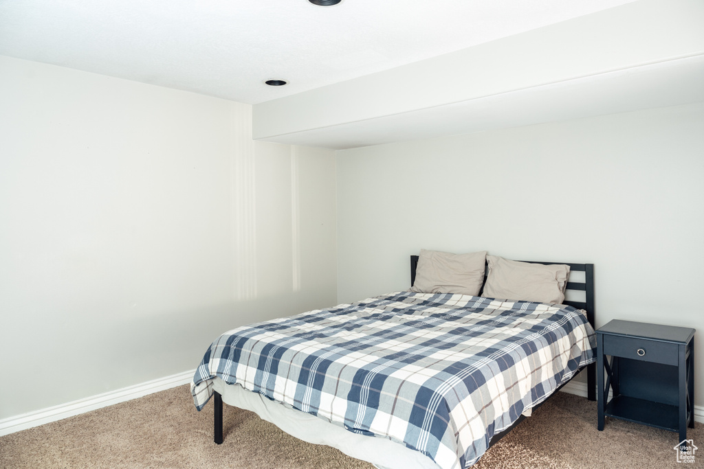 Carpeted bedroom featuring baseboards