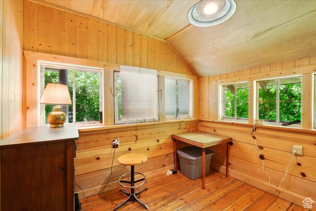 Sunroom featuring vaulted ceiling
