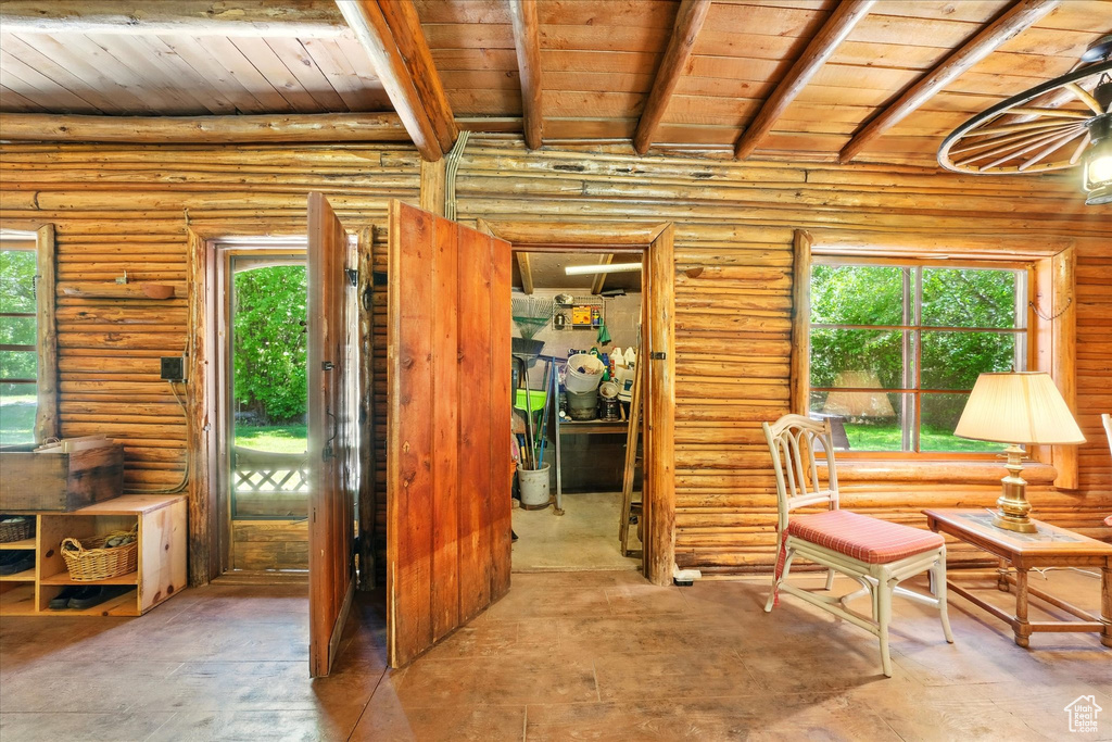 Sitting room featuring a wooden ceiling with exposed beams