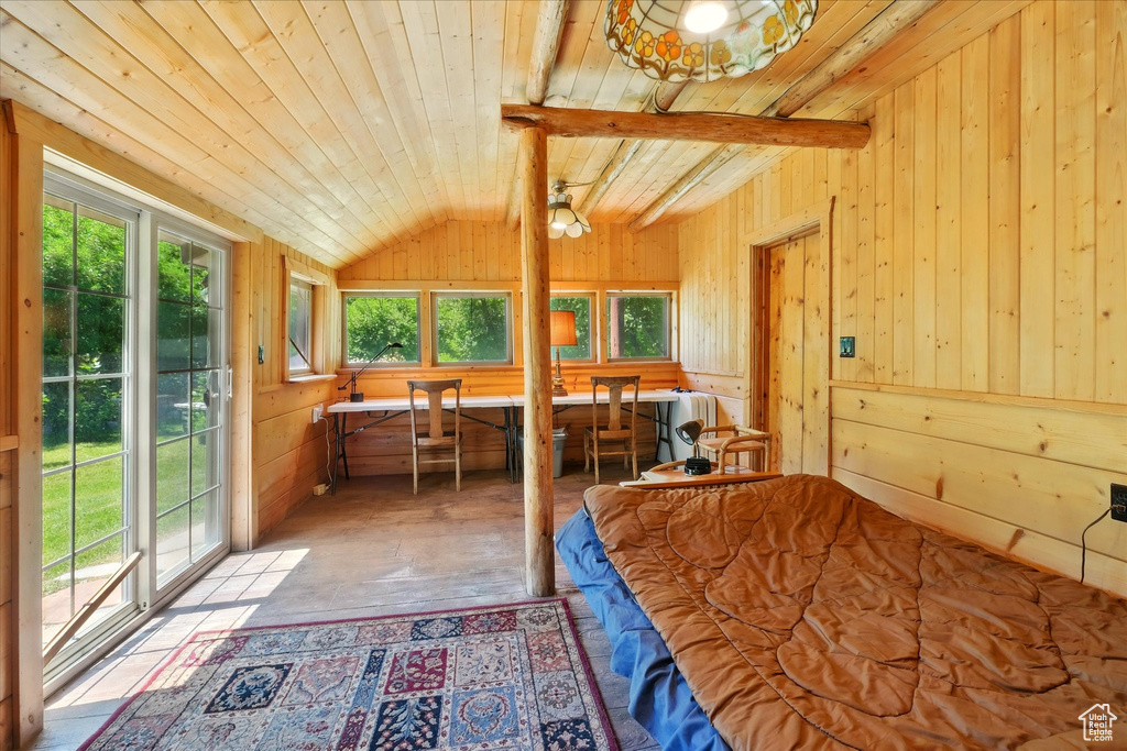 Bedroom with wood walls, wood-type flooring, wood ceiling, and access to exterior