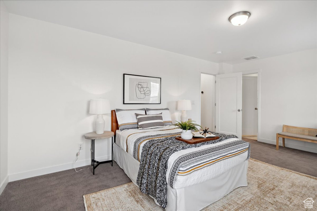 Carpeted bedroom featuring baseboards