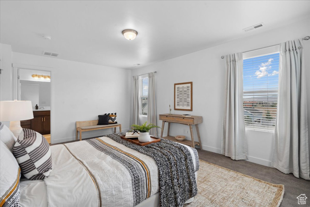 Bedroom with carpet flooring and baseboards