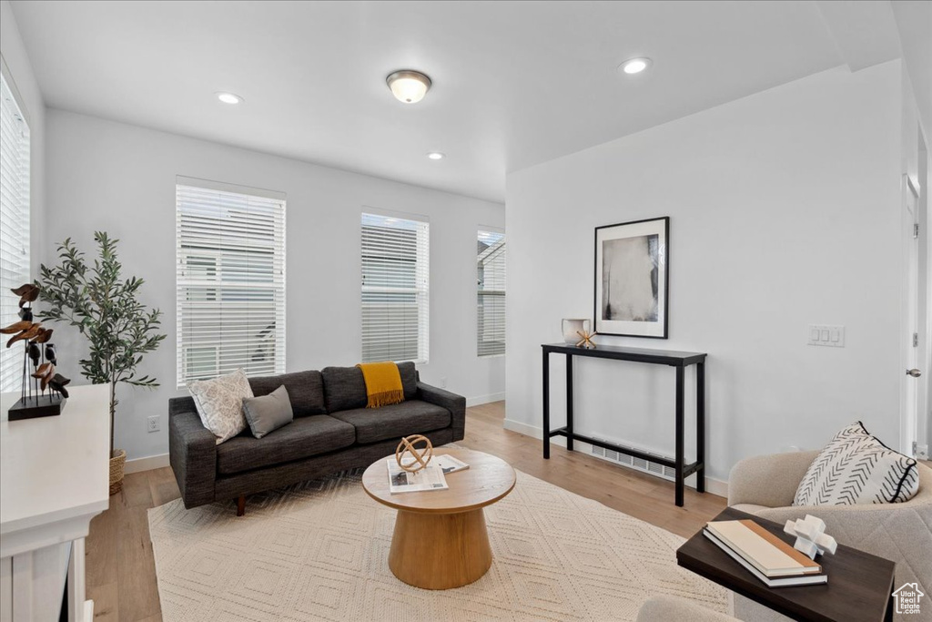 Living room featuring light wood finished floors and recessed lighting