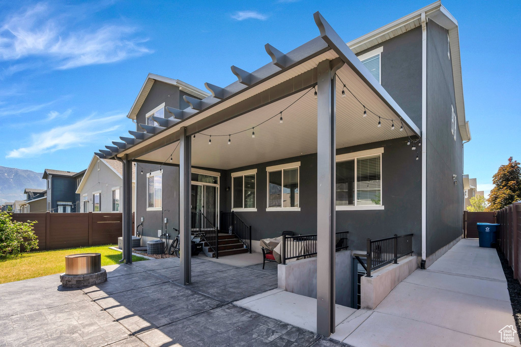 Rear view of house featuring stucco siding, a patio area, and entry steps