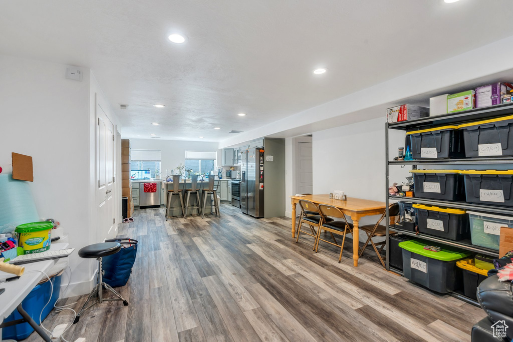 Office with wood finished floors and recessed lighting