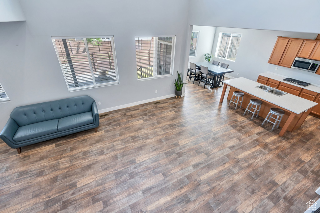 Sitting room featuring dark wood-style flooring and baseboards