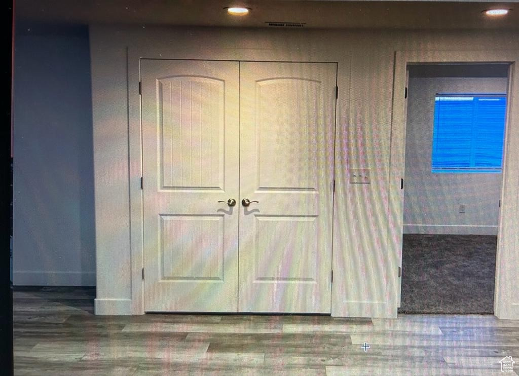 Detailed view of wood finished floors and recessed lighting