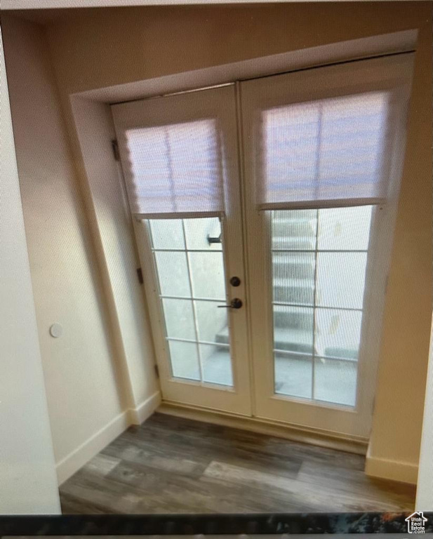 Doorway to outside with wood finished floors and french doors