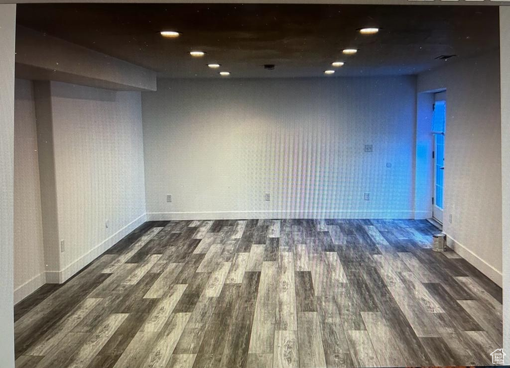 Empty room with wood finished floors and recessed lighting